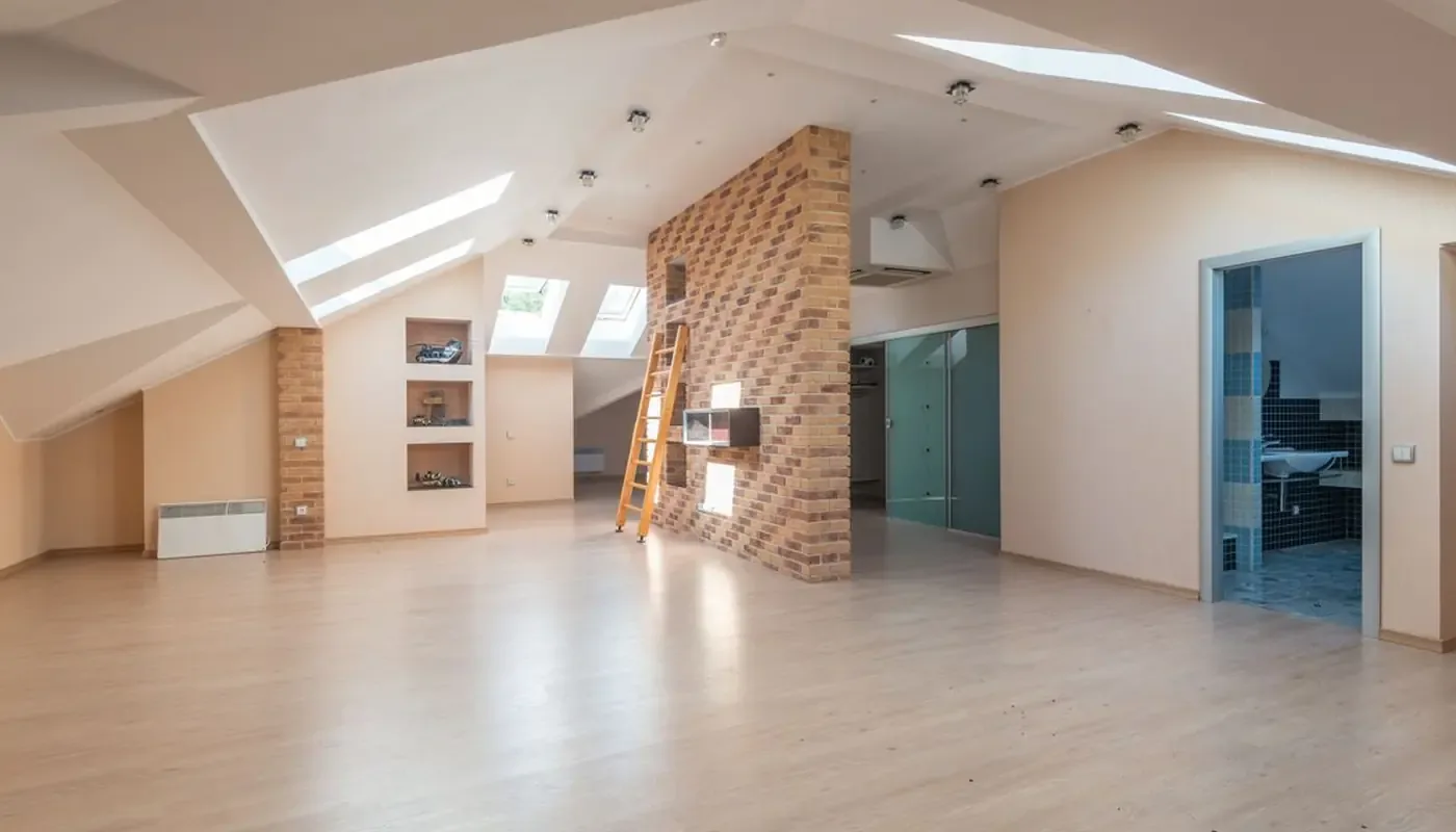 A bright open plan flat with timber floors and exposed brick, the kind of rented home a mid-term inspection records partway through a tenancy